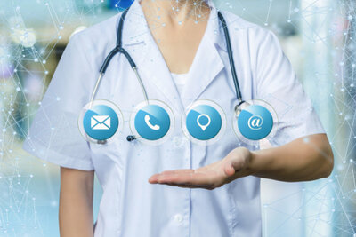 Medical staff member holding hand out with email, phone, location, and social media icons floating above hand.