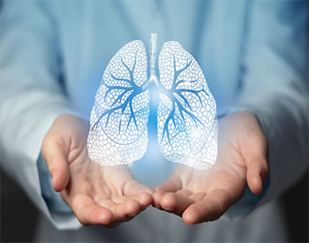 Lungs issues medical concept. Photo of female doctor with a set of holographic lungs.