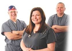 Three Medical Professionals smiling (one female & two males)