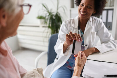 Female medical provider and a female patient in an office talking face to face.